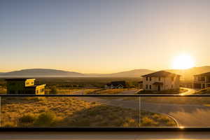 View of front of property with a mountain view and a balcony