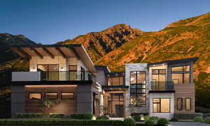 View of front of house featuring a balcony and a mountain view