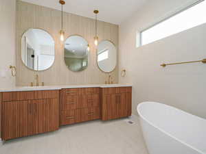 Bathroom featuring a freestanding tub and double vanity