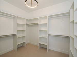Walk in closet featuring light carpet