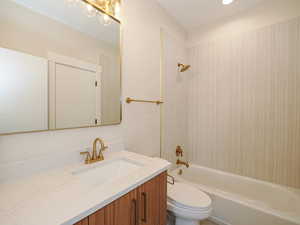 Full bathroom with shower / washtub combination, vanity, and toilet