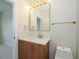 Bathroom featuring vanity and toilet