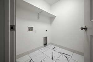 Laundry area featuring hookup for a washing machine, light marble finish flooring, electric dryer hookup, and baseboards