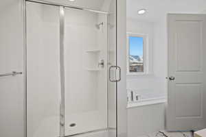 Full bathroom with a shower stall and a bath