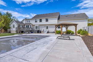 View of pool featuring a gazebo, a patio area, a wooden deck, and fence