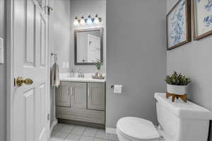 3/4 Bathroom featuring toilet, tile patterned floors, vanity, shower, and baseboards