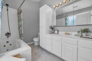 (3) Owners Bathroom featuring toilet, vanity, and a combined bath / shower with jetted tub
