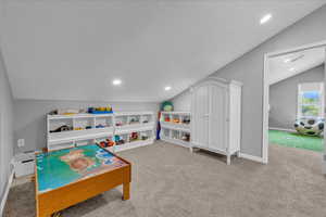 Game room featuring vaulted ceiling, carpet flooring, baseboards, a textured ceiling, and recessed lighting