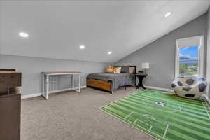 Room area featuring lofted ceiling