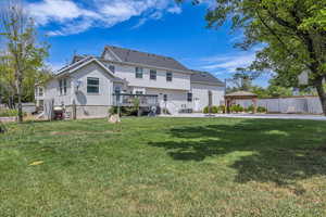 Rear view of property with a gazebo and a wooden deck