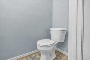 Bathroom with baseboards and toilet