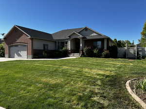 View of front of home featuring brick siding, an attached garage, and concrete driveway