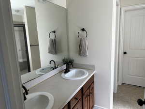 Full bath with a stall shower and double vanity