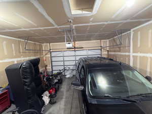 Garage featuring a garage door opener