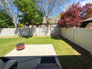 View of yard with an outdoor fire pit and a fenced backyard