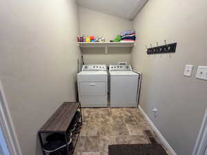 Laundry area with washer and dryer, laundry area, stone finish floor, visible vents, and baseboards