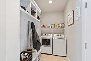 Washroom featuring independent washer and dryer, recessed lighting, and baseboards