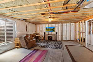 Basement featuring washing machine and dryer and a lit fireplace