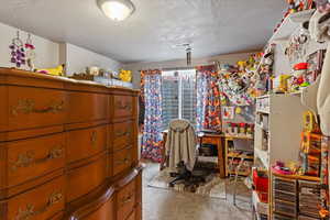 Bedroom featuring a textured ceiling and carpet floors