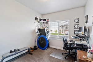 Office area featuring carpet floors and baseboards