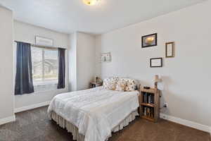 Bedroom with carpet flooring and baseboards