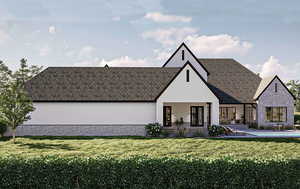 View of front facade featuring a patio area, a front lawn, and stone siding