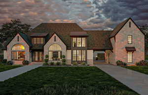 View of front of house with concrete driveway, a front yard, and stone siding