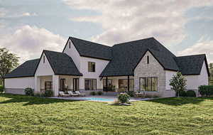 Back of property featuring a lawn, a patio area, an outdoor pool, and stone siding