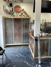 Bar with concrete flooring and an AC wall unit