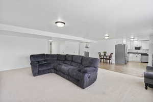 Living room with light carpet and baseboards