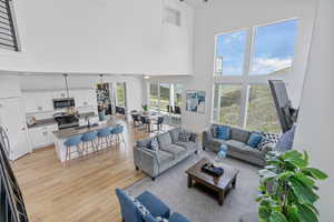 Living room with a high ceiling and light wood finished floors