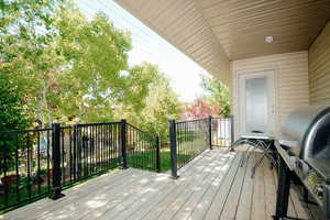 Wooden terrace featuring grilling area