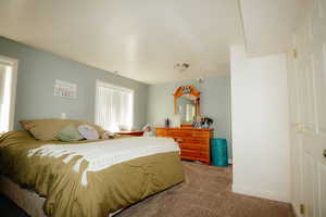 Bedroom with light carpet and baseboards