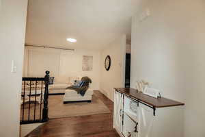 Living area featuring dark wood finished floors, baseboards, and recessed lighting