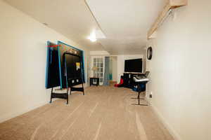 Recreation room featuring carpet flooring and baseboards