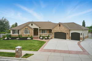 Ranch-style house with a garage, concrete driveway, brick siding, and roof with shingles
