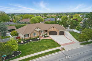 Ranch-style house featuring a garage, concrete driveway, and brick siding