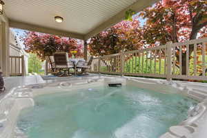 View of swimming pool featuring a hot tub