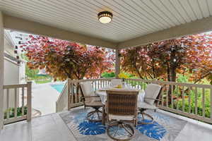 View of patio featuring outdoor dining space, an outdoor pool, and a wooden deck