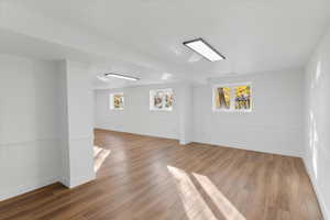 Empty room with light wood-type flooring and baseboards