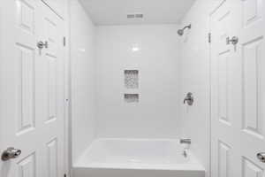 Full bath featuring  shower combination and visible vents