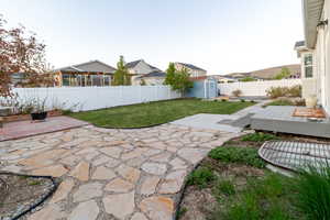 View of yard featuring a patio area, a shed, an outdoor structure, and a deck