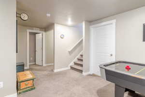 Recreation room with carpet floors and baseboards