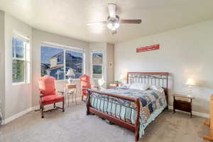 Bedroom with carpet floors, baseboards, and ceiling fan