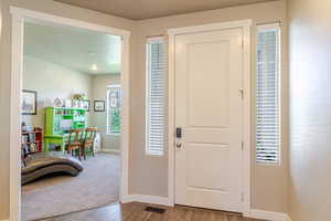 Foyer entrance featuring baseboards and wood finished floors