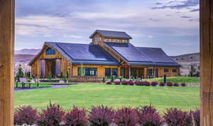 View of front of house featuring a mountain view, a front lawn, a standing seam roof, and metal roof