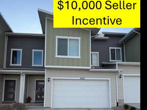 Multi unit property featuring board and batten siding, driveway, and a garage