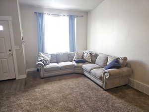 Living room with carpet and baseboards