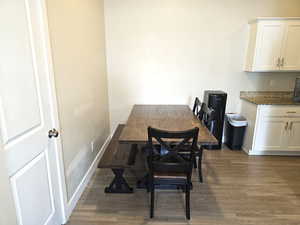 Dining room with dark wood finished floors and baseboards