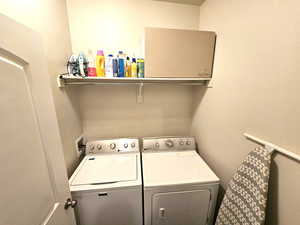 Laundry room with washer and clothes dryer